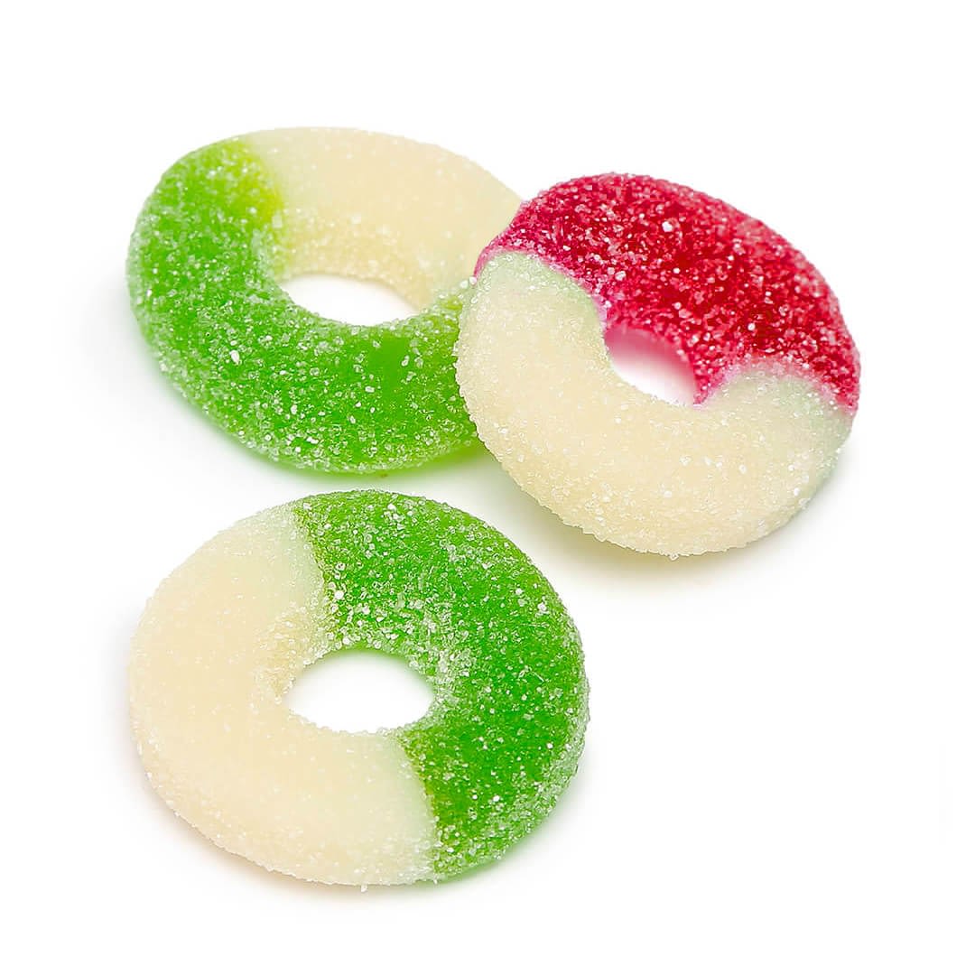 Enjoy three Delta 9 Watermelon and Apple Rings: one green and white, one partially dipped in red, delivering a delightful THCp-infused flavor experience.