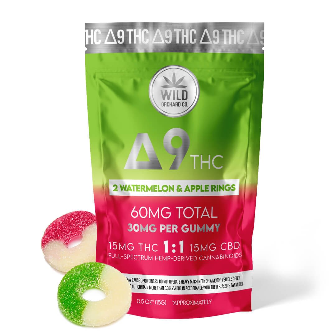 A package of Delta 9 Watermelon and Apple Rings from Wild Orchard Co. sits beside two delicious gummies. Each gummy is infused with 15mg THC and 15mg CBD, totaling 60mg. They're ideal for pairing with your HHC-R carts for a balanced experience.