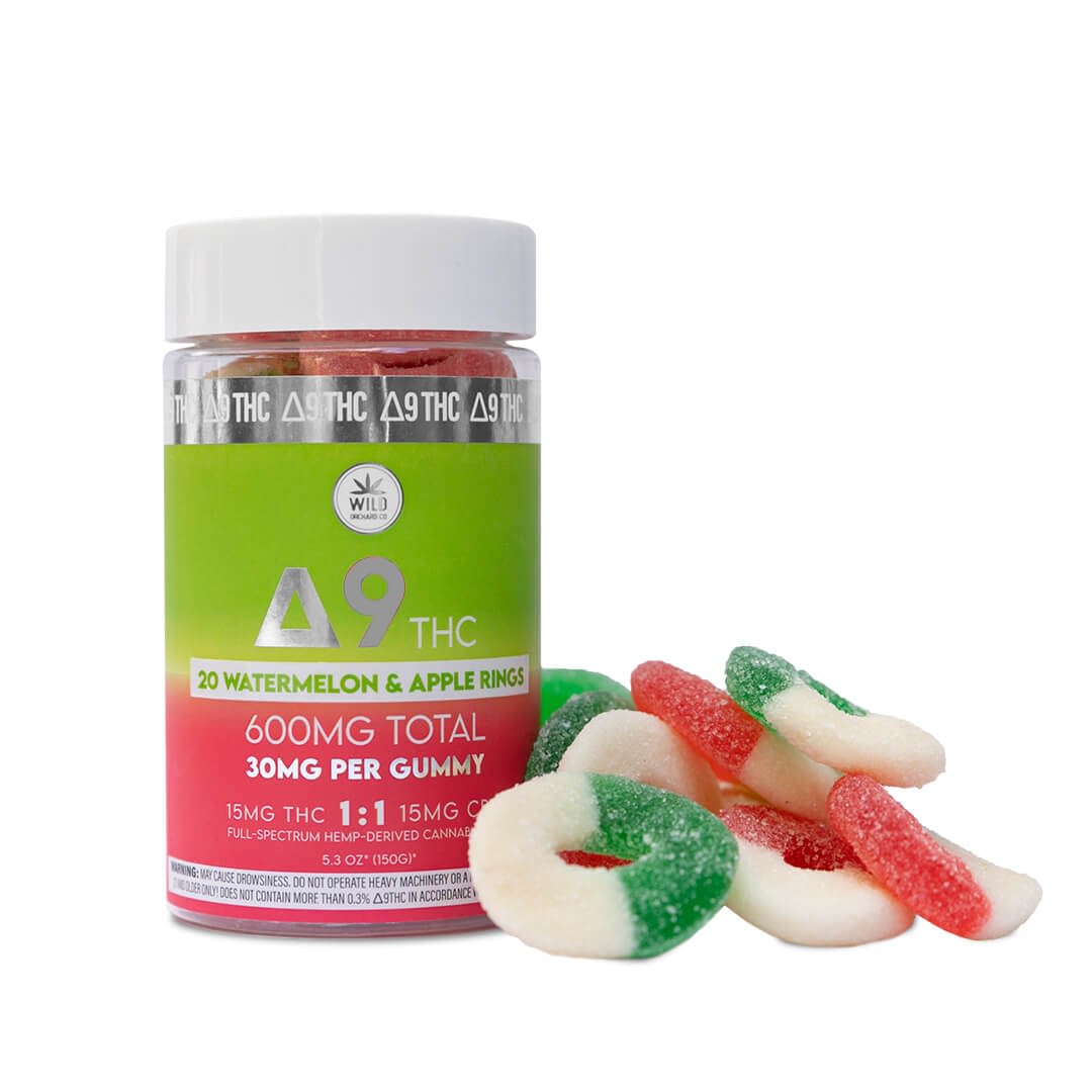 A jar labeled "20 Watermelon & Apple Rings" with "600mg Total" and "30mg Per Gummy" sits beside a few vibrant edibles, offering a delicious alternative to vaping.