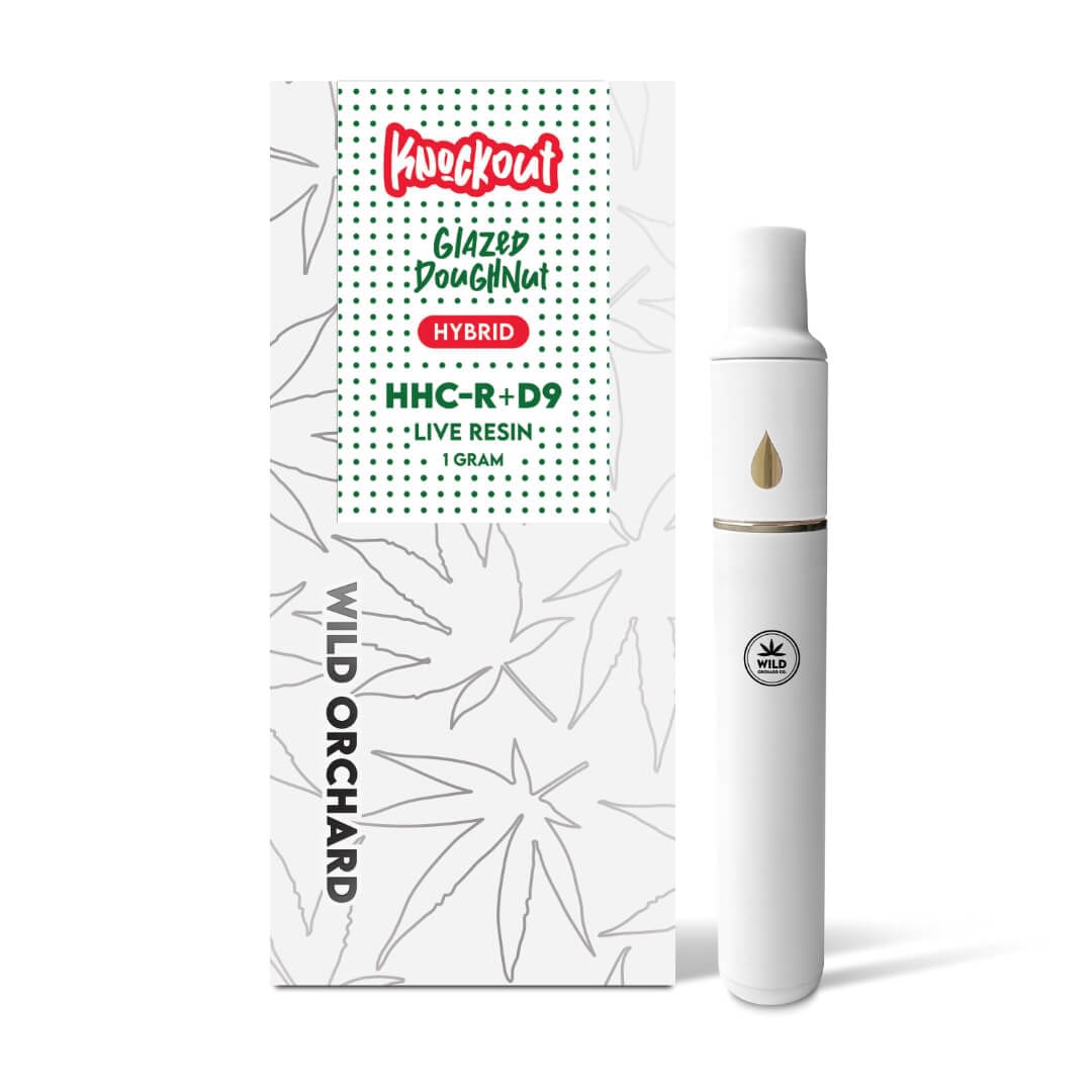 White vape pen and box labeled "Knockout 'Strawberry Cough' HHC-R Live Resin 1 Gram" with leaf pattern design, branded "Wild Orchard." This premium vape offers a distinctive experience for connoisseurs valuing quality craftsmanship and innovation in cannabis products.
