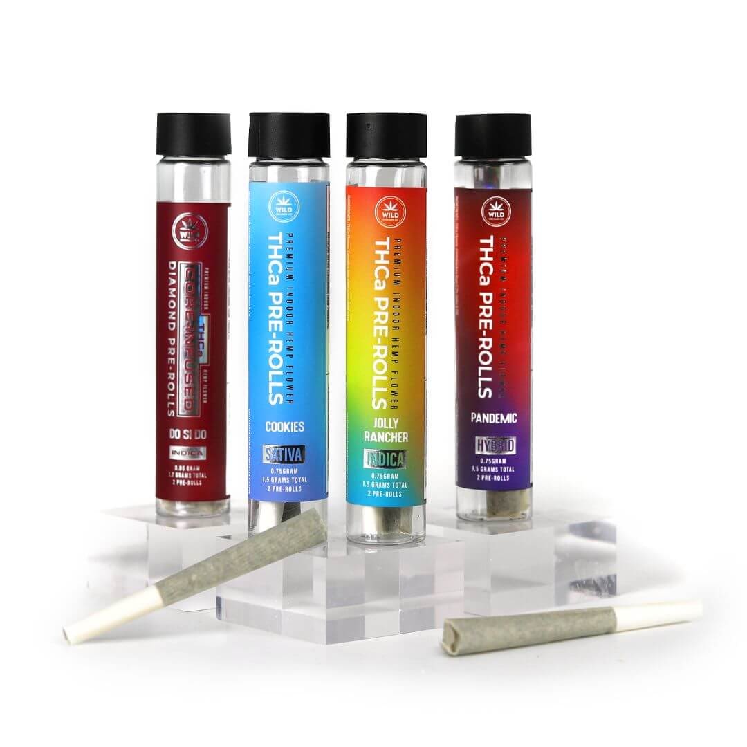 Four THCa Pre-Roll Bundles in different flavors labeled sativa, indica, and hybrid, with one joint lying horizontally in front of them on a white background.