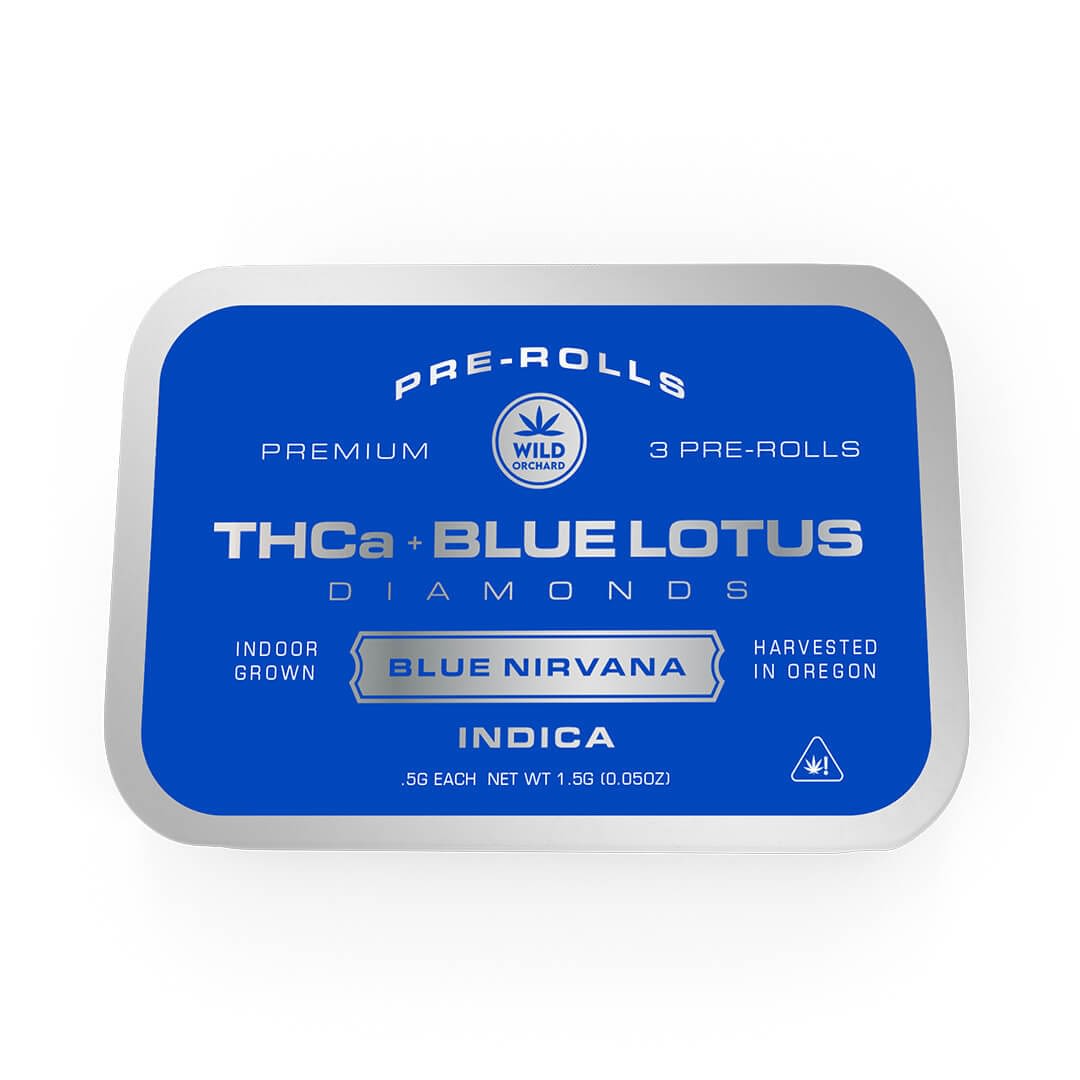 A rectangular metal tin labeled "Blue Lotus THCa Diamonds Pre-Rolls" holds three indica pre-rolls called "Blue Nirvana," crafted with THCa Diamonds and Blue Lotus, indoor grown and harvested in Oregon.