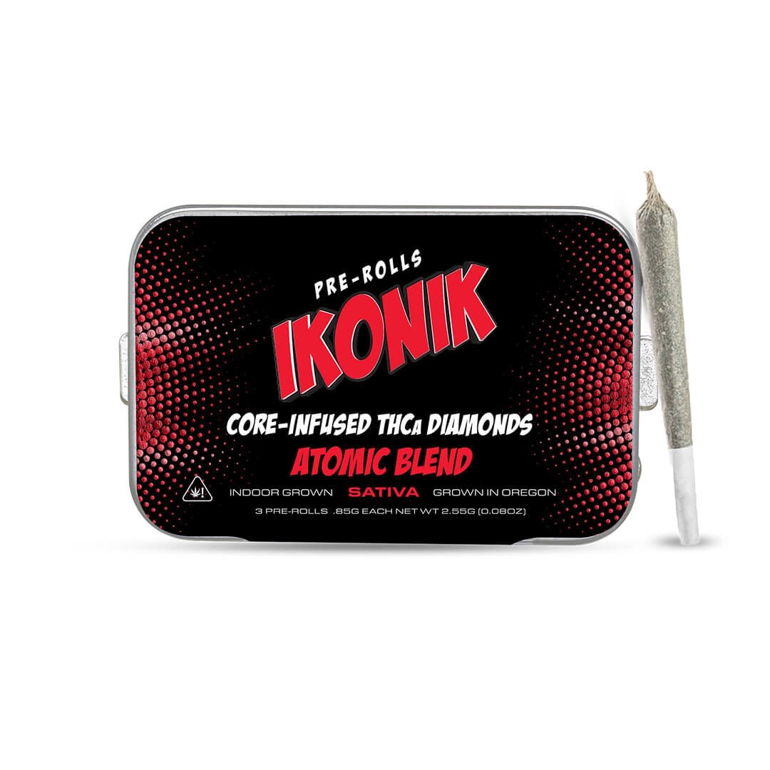 A tin labeled "IKONIK Pre-Rolls Atomic Blend" with a pre-rolled joint beside it. The tin features red and black comic-style graphics and product details.
