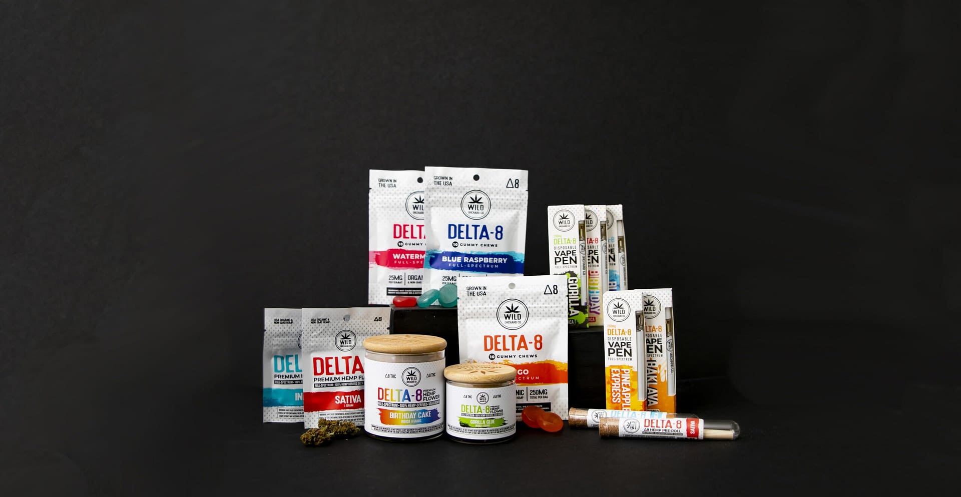 Assorted Delta-8 THC products, including HHC-R vape pens, gummies, and jars, are displayed against a sleek black background.