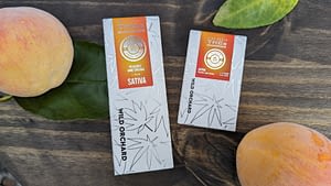 A box of peaches and a box of cbd oil.