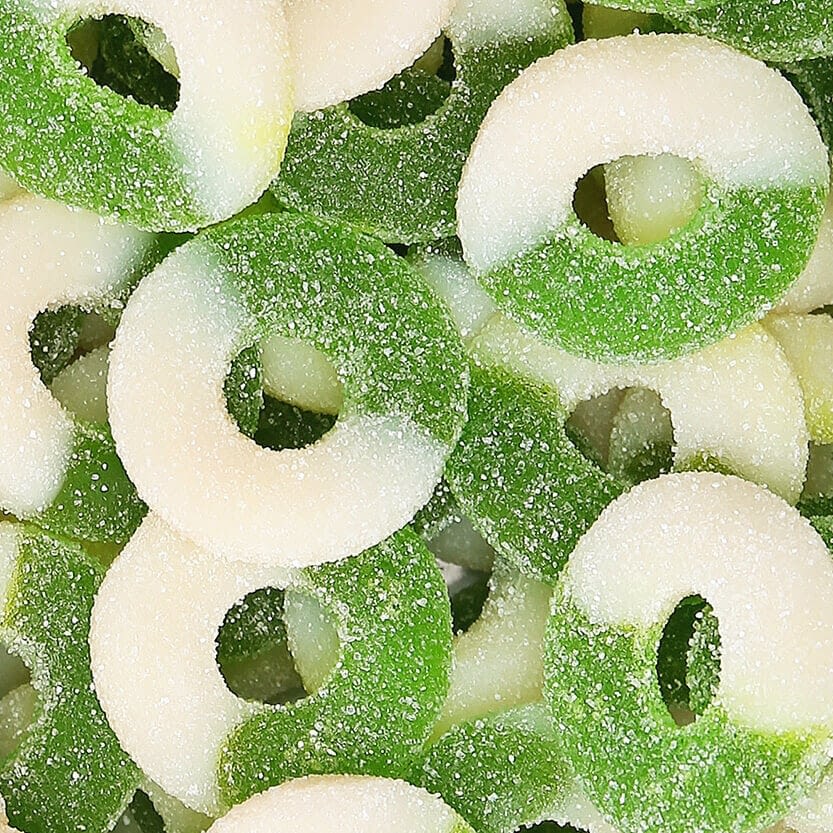 A stack of green and white Delta 9 Watermelon and Apple Rings entices with their sugar-coated sweetness, delivering a delightful hint of THCp bliss in every bite.